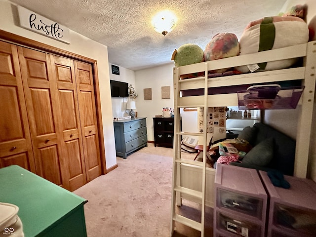 bedroom with light carpet, a closet, and a textured ceiling