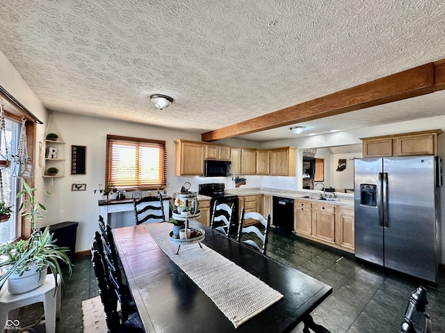 dining space featuring sink and a textured ceiling