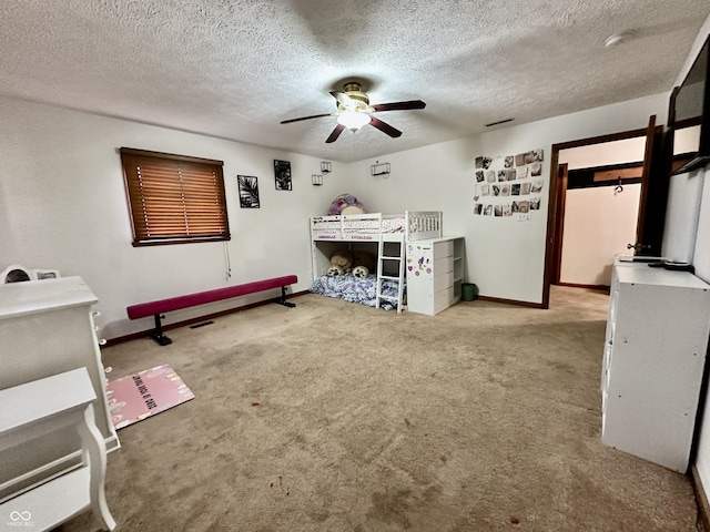 unfurnished bedroom with ceiling fan, carpet, and a textured ceiling