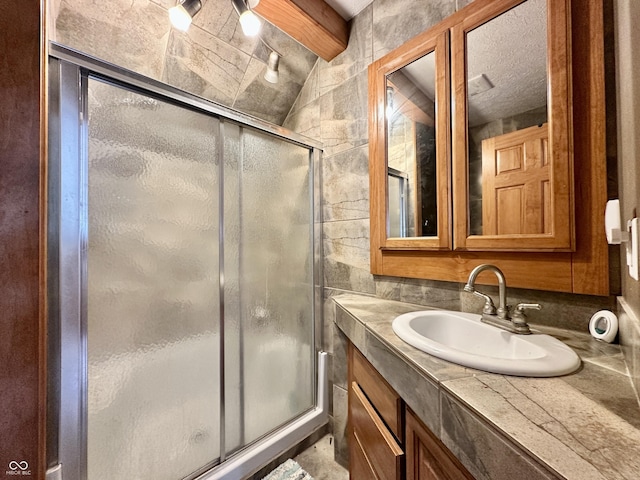 bathroom with an enclosed shower and vanity