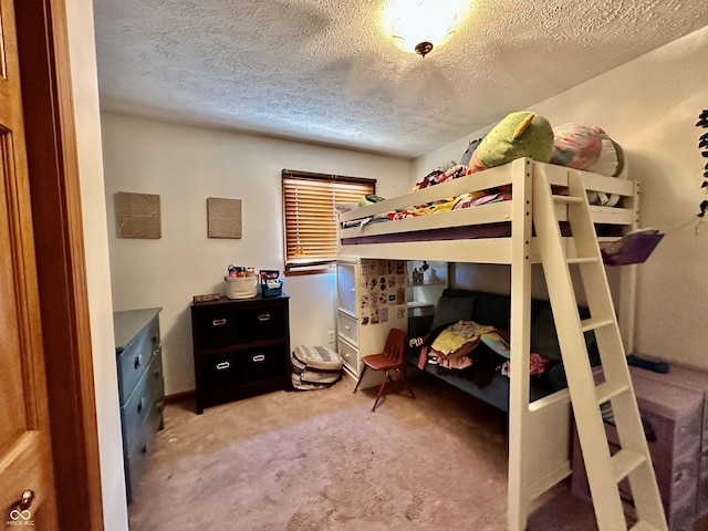 bedroom with light carpet and a textured ceiling