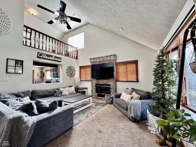 carpeted living room featuring a textured ceiling, a fireplace, high vaulted ceiling, and ceiling fan