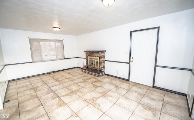 tiled empty room with a brick fireplace