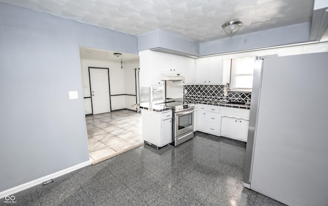 kitchen with appliances with stainless steel finishes, sink, white cabinets, and decorative backsplash