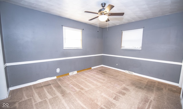 empty room with ceiling fan and carpet