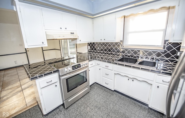 kitchen with electric range and white cabinets