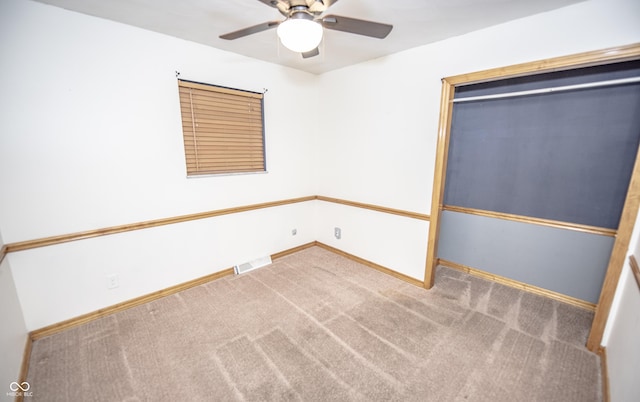 carpeted empty room with ceiling fan