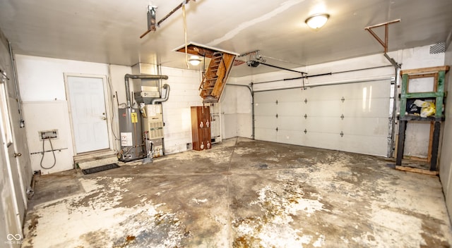 garage with a garage door opener and water heater