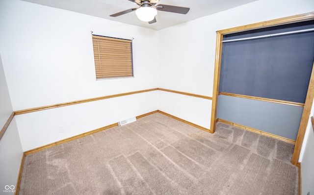 spare room featuring carpet floors and ceiling fan