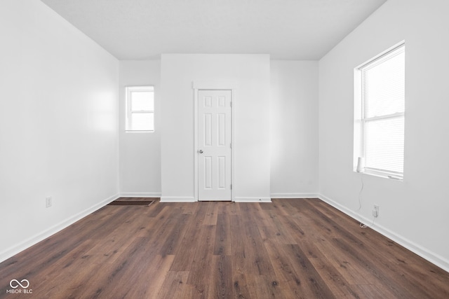 empty room with dark hardwood / wood-style floors