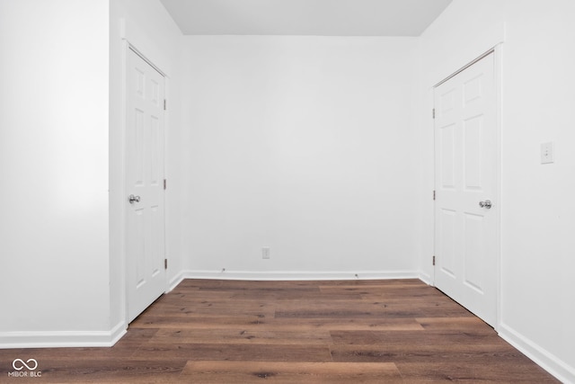 empty room with dark hardwood / wood-style floors