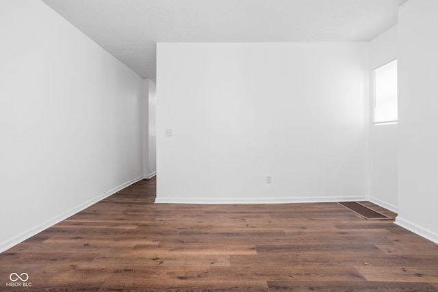 spare room featuring dark hardwood / wood-style flooring