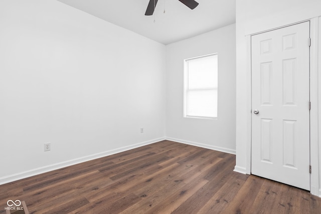 empty room with dark hardwood / wood-style floors and ceiling fan