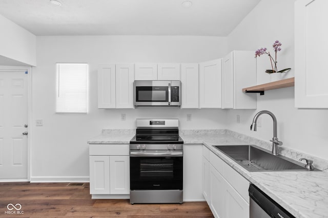 kitchen featuring light stone countertops, appliances with stainless steel finishes, sink, and white cabinets