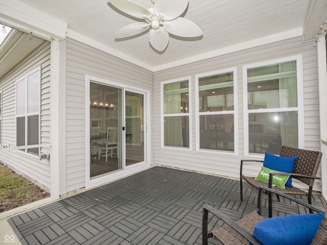 sunroom featuring a ceiling fan