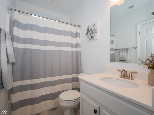 bathroom featuring toilet, a shower with curtain, visible vents, and vanity