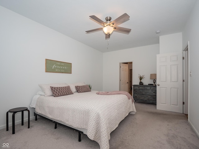 bedroom with baseboards, a ceiling fan, and light colored carpet