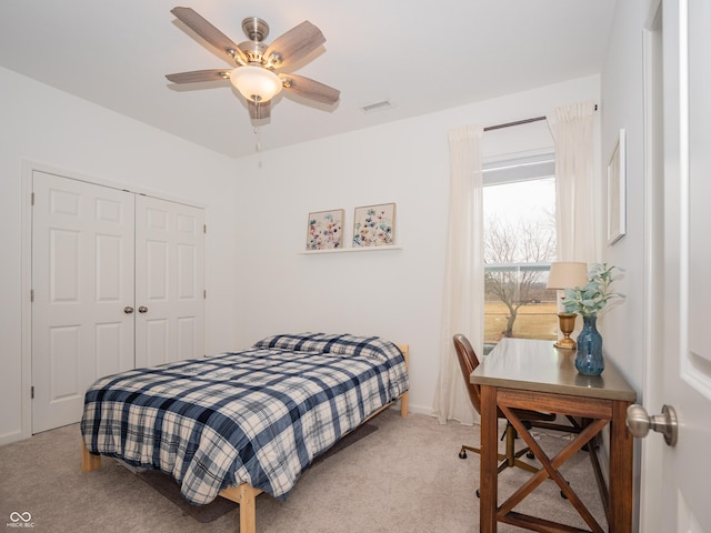 bedroom with ceiling fan, a closet, carpet flooring, and visible vents