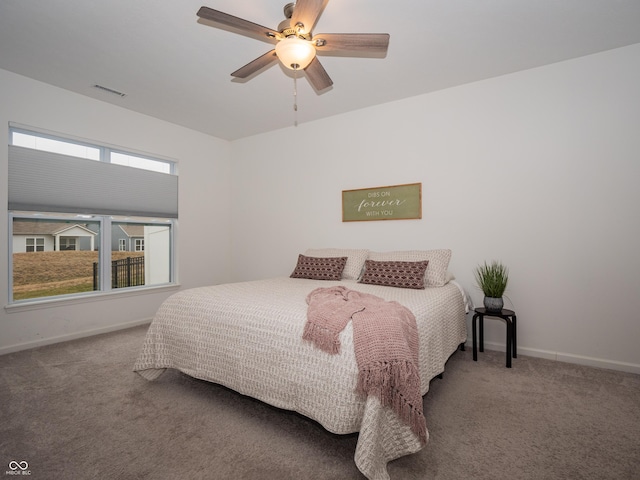 carpeted bedroom with ceiling fan, visible vents, and baseboards