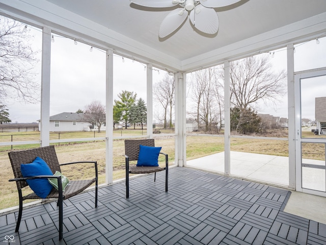 sunroom featuring ceiling fan