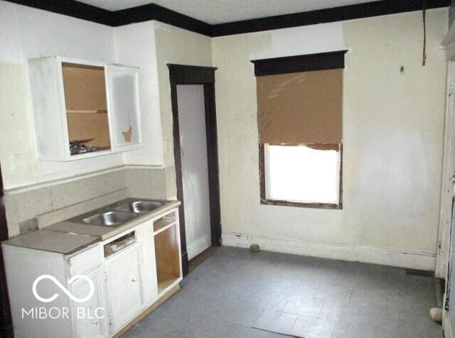 kitchen featuring sink and white cabinets