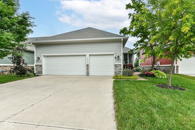 view of front of property with a garage and a front lawn