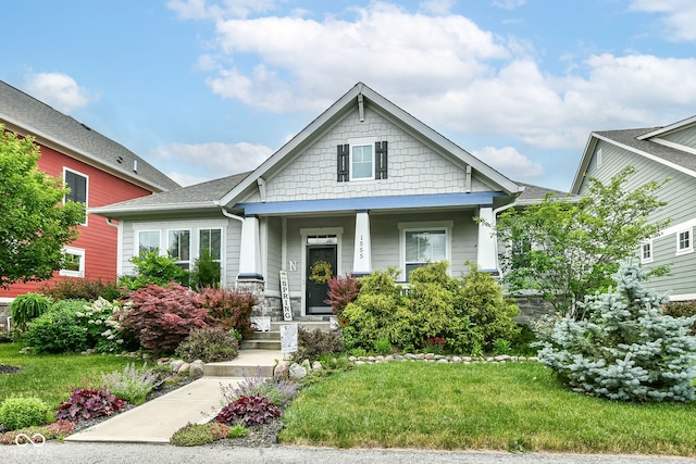 craftsman-style house featuring a front yard and a porch