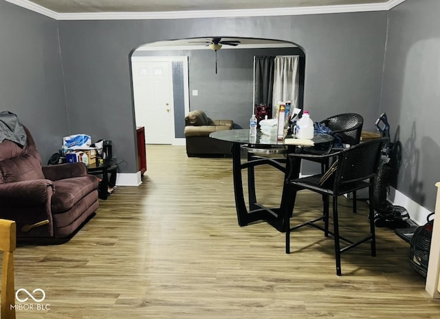 dining room featuring crown molding, ceiling fan, and light wood-type flooring