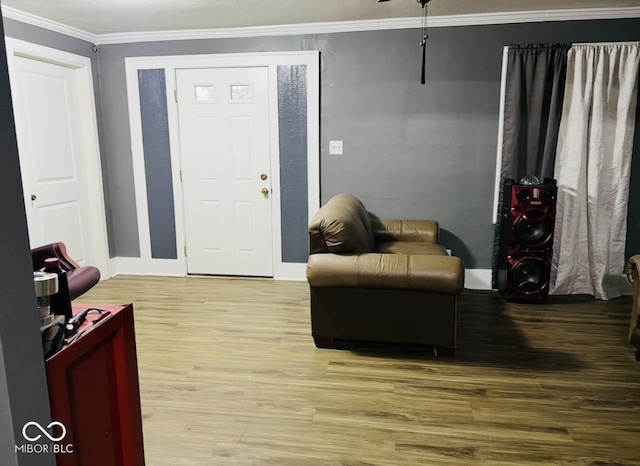 entryway with hardwood / wood-style floors and ornamental molding