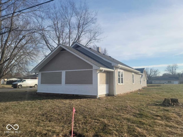 view of property exterior with a lawn