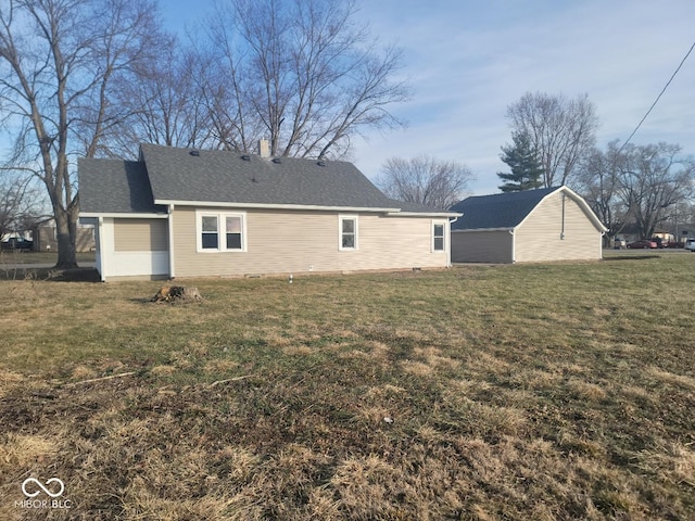 rear view of property featuring a lawn