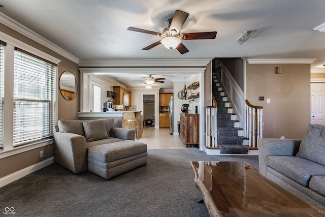 tiled living room with ceiling fan, ornamental molding, and a textured ceiling