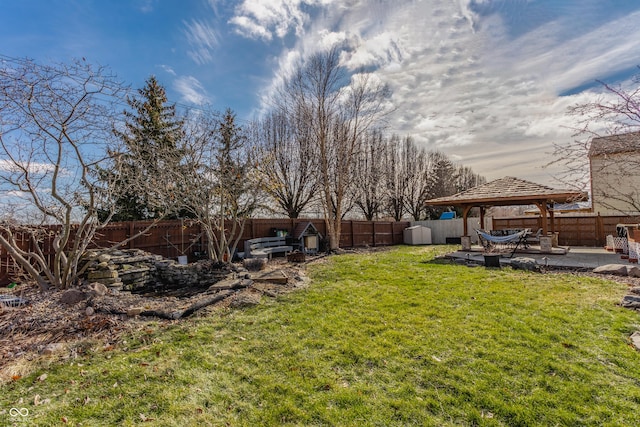 view of yard featuring a gazebo, a patio, and a storage unit