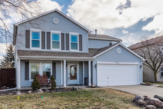 view of property featuring a garage and a front lawn