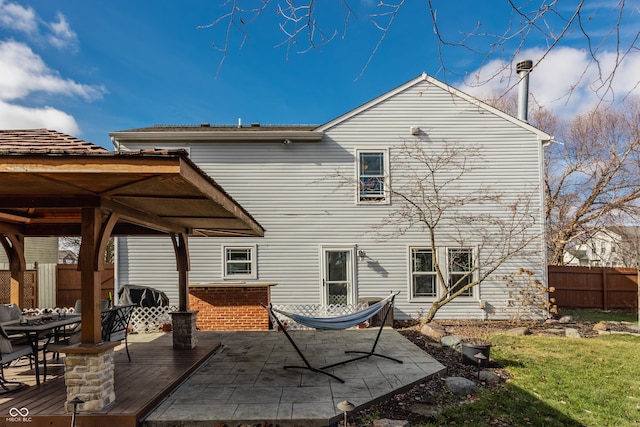 back of property with a wooden deck