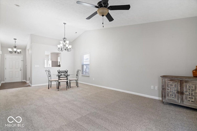 unfurnished dining area with vaulted ceiling, carpet, ceiling fan with notable chandelier, and a textured ceiling