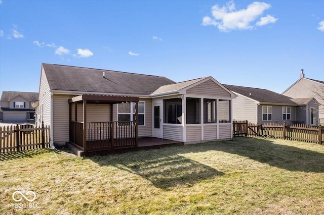 back of property featuring a yard and a sunroom