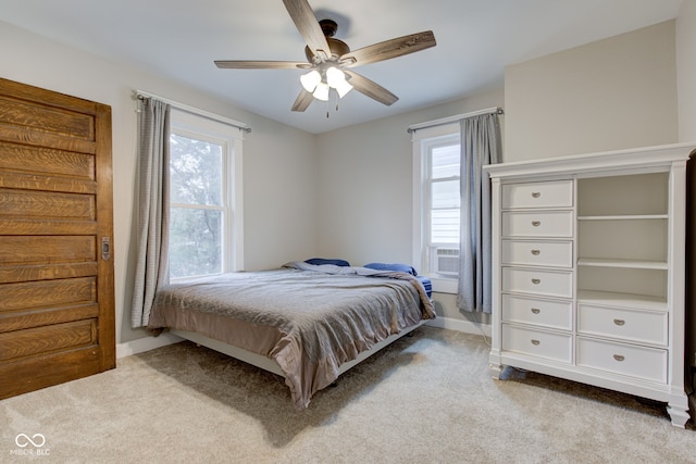 carpeted bedroom with cooling unit and ceiling fan