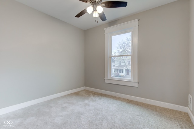 unfurnished room with ceiling fan and carpet