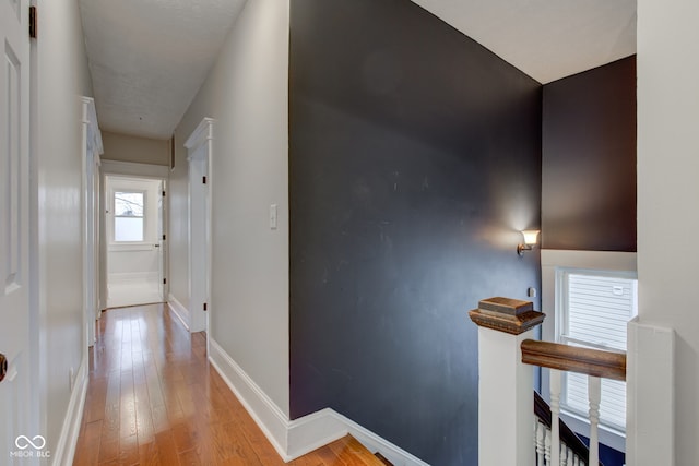 hallway with light hardwood / wood-style floors