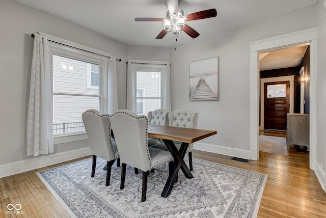 dining space featuring ceiling fan and light hardwood / wood-style flooring