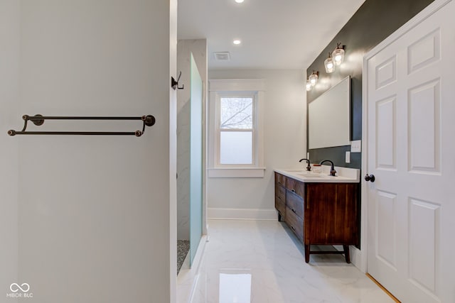 bathroom featuring a shower and vanity