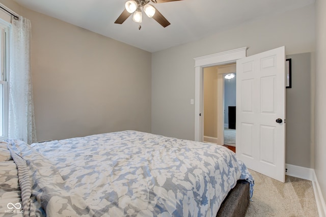 bedroom featuring light carpet and ceiling fan