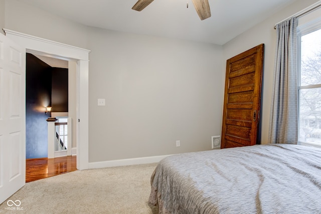 carpeted bedroom with ceiling fan