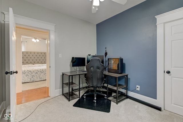 carpeted home office with ceiling fan