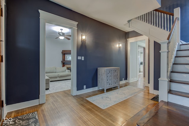 foyer entrance with wood-type flooring and ceiling fan