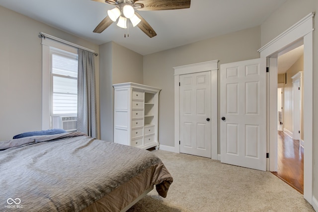 carpeted bedroom featuring cooling unit, a closet, and ceiling fan