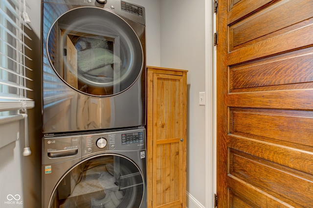 washroom featuring stacked washer / dryer