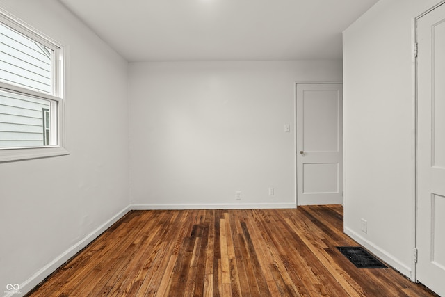 spare room featuring dark hardwood / wood-style floors