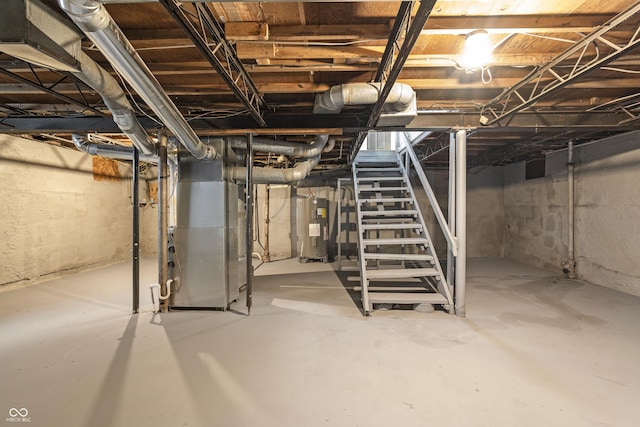 basement featuring electric water heater and heating unit